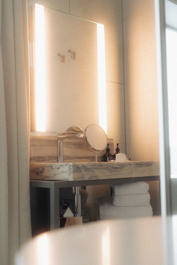 Marble sink and illuminated mirror detail