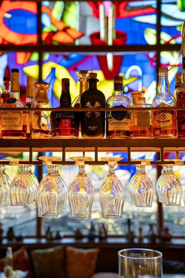 Spirit selection and glassware against stained glass background