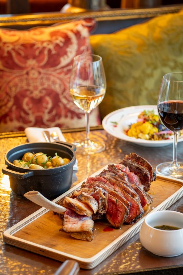 Sliced Tomahawk steak and roasted baby potatoes